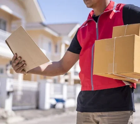 depositphotos_222618648-stock-photo-delivery-man-red-uniform-standing